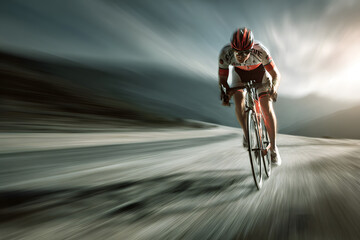 Competitive cyclist racing on a winding road in a dramatic landscape during a sunny day
