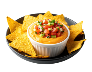 A bowl of cheesy dip topped with diced vegetables, surrounded by tortilla chips, on a black plate