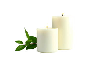 Lit ivory candles flank greenery; warm, peaceful ambiance created