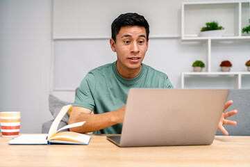 Young man engaging in virtual meeting from home