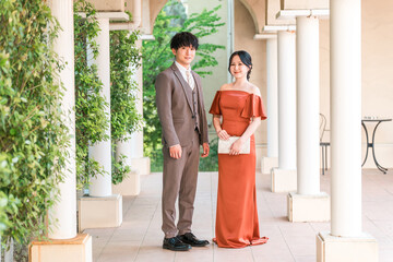 Wedding reception, after-party, bride and groom appearing in wedding color dresses, dressed up...