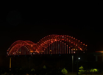The Hernando de Soto Bridge Crossing the Mississippi River in Memphis Illuminated with Red Lights