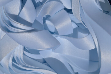 a bunch of stacked light blue ribbons. satin textured lanyard ribbon pieces