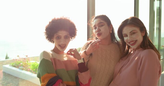Soundtrack initiating diverse female friends with facial masks lip-syncing and dancing at home