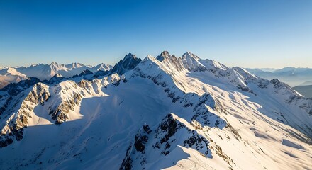Majestic Snow Covered Mountain Range Under a Clear Blue Sky.