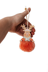 Cute reindeer Christmas ornament with fluffy pompom held by hand