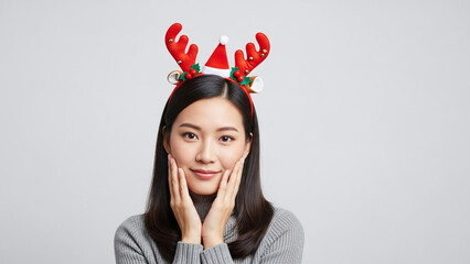Portrait of a woman wearing a simple holiday headband reindeer antlers casual winter outfit