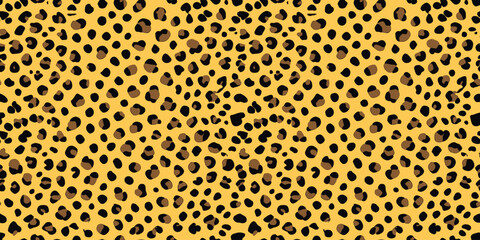 Vibrant animal print pattern featuring bold black spots on a golden yellow background.