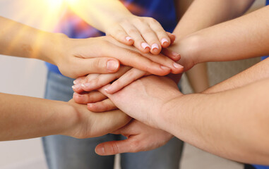 Group of volunteers stacking hands, closeup. Banner design