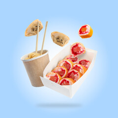 Asian food falling on light blue background