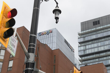 Fototapeta premium skyward view of Google signs at top of Google King East, corporate office, 65 King St E, Toronto