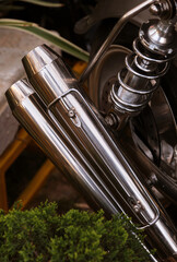 Close-up of the exhaust pipe of a vintage motorcycle.