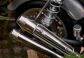Close-up of the exhaust pipe of a vintage motorcycle.