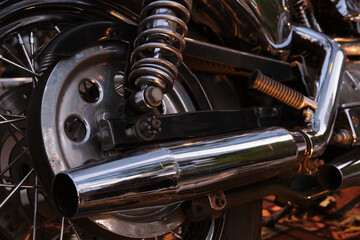 Close-up of the exhaust pipe of a vintage motorcycle.