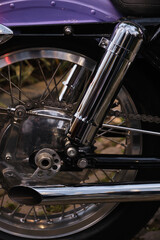 Close-up of the exhaust pipe of a vintage motorcycle.