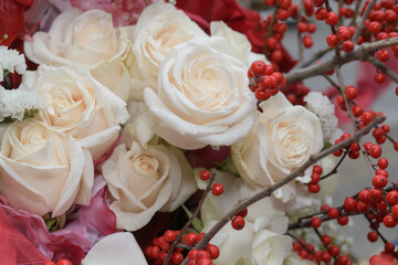 floral background featuring roses and red berries