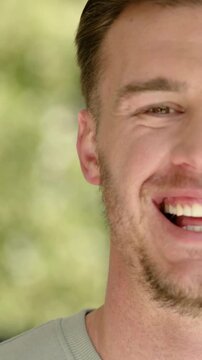 Vertical video: Smiling man at window in shirt hearing offstage voice, turning, camera pulling back