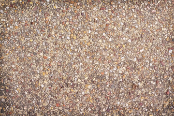 Gravel stone on brown wall background