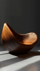 Smooth modern wooden chair with curved flowing design and textured grain pattern illuminated by soft natural light in minimalist setting