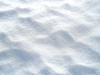 Obraz premium Close-up view of soft, freshly fallen snow with small mounds and a smooth, powdery texture under diffused light