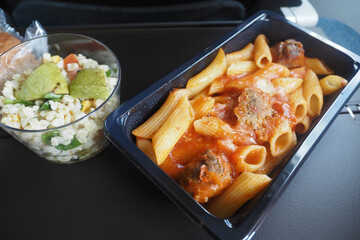 Pasta meal served on an airplane during flight