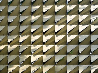 Close-up of a rows golden abstract triangle pattern. Decorative abstract pattern for an outdoor wall application.
