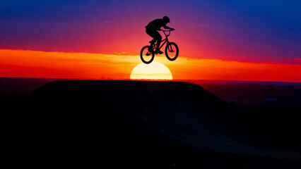 Obraz premium Bmx sunset silhouette jump extreme sport bike bicycle rider action adventure sky clouds sun dusk dawn freedom challenge skill adrenaline outdoor lifestyle competition trick