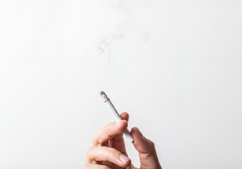 Human Hand Holding Burning Cigarette with Rising Smoke Against White Background