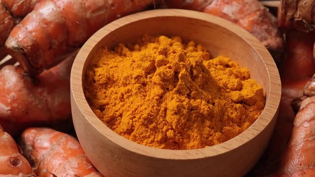 Turmeric powder in a wooden cup