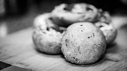 A close-up photograph of fresh mushrooms prepared in a kitchen setting, showcasing detailed textures, natural colour, and organic surfaces. Suitable for themes related to cooking.