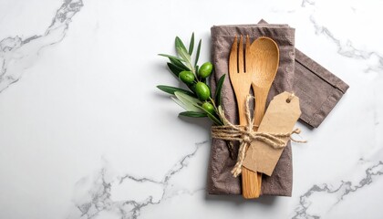 Olive & wooden cutlery on cloth