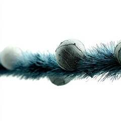 Festive grey and white Christmas baubles on a metallic blue tinsel garland