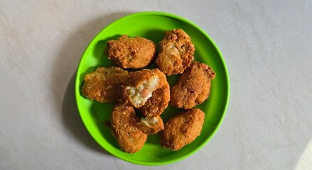 A plate of fried grated cassava named combro in Bahasa 