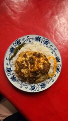 Rice with fried eggs on the red background 