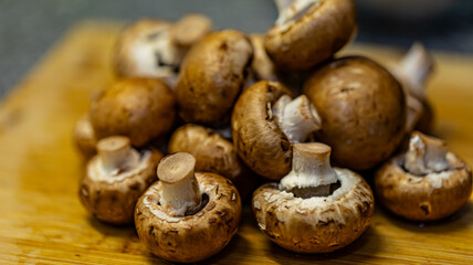 A close-up photograph of fresh mushrooms prepared in a kitchen setting, showcasing detailed textures, natural colours, and organic surfaces. Suitable for themes related to cooking.