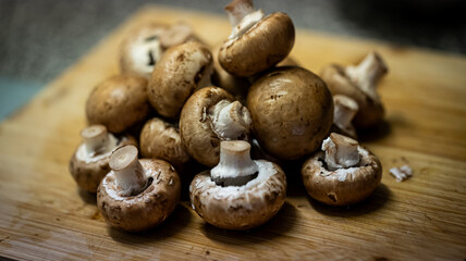 A close-up photograph of fresh mushrooms prepared in a kitchen setting, showcasing detailed textures, natural colours, and organic surfaces. Suitable for themes related to cooking.