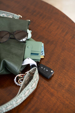 A green bag with wallet and keys, with Australian money