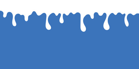 drops of milk falling down on a blue background