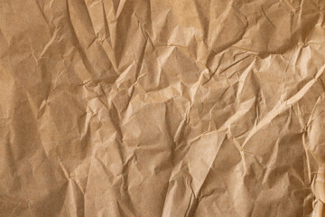 Obraz premium Crumpled brown paper texture,Close-up view of crumpled brown paper. Abstract pattern of crumpled brown paper. Crumpled brown paper texture background