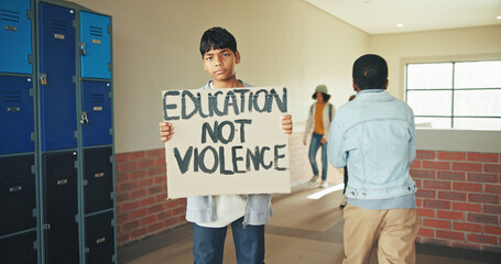 Portrait, school and boy with sign, protest and education with placard, teenager and protection. Anti bullying, student and child in hallway, activism or banner to promote safety, study and awareness