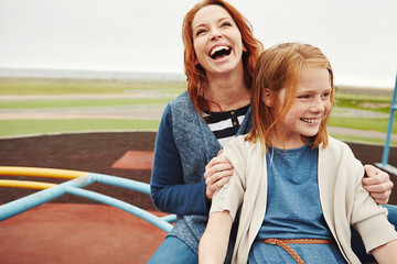 Roundabout, playground and mother with child outdoor with laughing, fun and bonding together. Happy, family and mom with girl kid spinning in park for development, connection or growth on holiday.