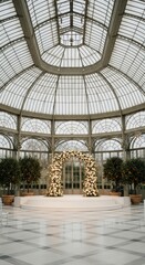 Obraz premium A glass structure with an archway of flowers and trees in pots inside a building with marble floors
