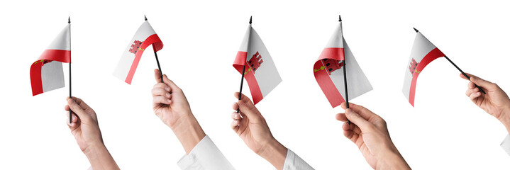 The Gibraltar flag in hand in different angles on a white background