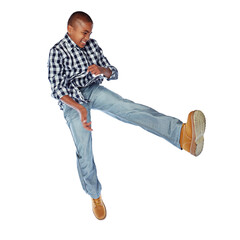 Naklejka premium Child, kick and jump in studio with energy, fashion celebration and cool outfit. African kid, boy and model leap for freedom, stylish jeans or happiness isolated on white background space for winning