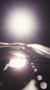 vertical slow motion macro close up of woman playing piano focus on movement of hands and rhythm concept of art of sound creative inspiration elegance and timeless artistic expression