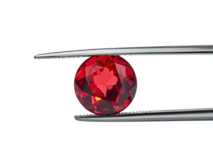 A faceted, round gemstone is held by tweezers against a black background, reflecting light