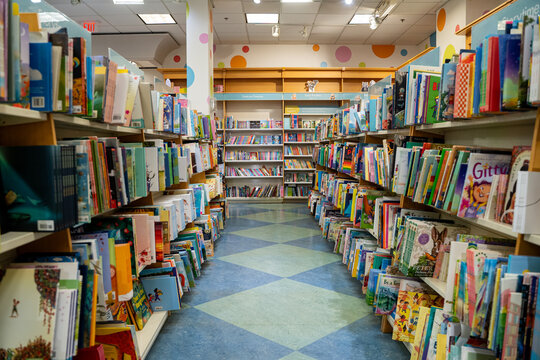 View of a colorful children's book aisle inside a bookstore. Toronto, Canada - December 3, 2025.