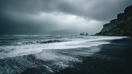 Fototapeta premium Exploring Black Sand Reynisfjara Beach With Basalt Columns and Crashing Ocean Waves on a Cloudy Day