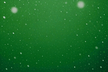 Green winter background with falling snow particles, creating a festive and seasonal Christmas atmosphere perfect for holiday designs and decorations.