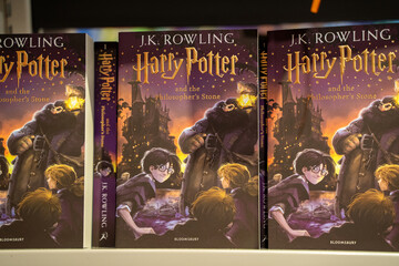 Naklejka premium Close up of Harry Potter and the Philosopher's Stone book covers. Toronto, Canada - December 3, 2025.